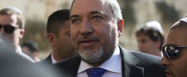 JERUSALEM, ISRAEL &#8211; NOVEMBER 06: Former Israeli Foreign Minister, Avigdor Lieberman is surrounded by supporters and security as he visits at the Western wall after the verdict on charges of fraud and breach of trust was given on November 6, 2013 in Jerusalem, Israel. Concerning incidents which took place more than a decade ago, Lieberman was accused of trying to advance the career of a former diplomat who relayed information to him about a since closed criminal investigation into his business dealings. Lieberman was unanimously acquitted by a panel of three judges in a hearing which lasted just a few minutes. (Photo by Uriel Sinai/Getty Images)
