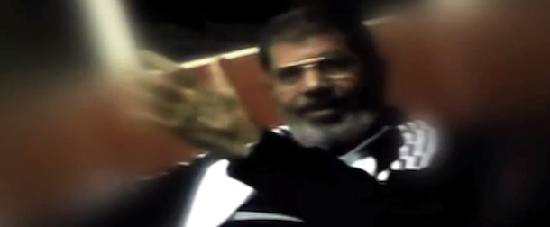 This image made from undated video posted on the website of the el-Watan newspaper on Sunday, Nov. 3, 2013, shows ousted President Mohammed Morsi during his detention at an undisclosed facility in Egypt following his ouster. A newspaper known for close ties to the military published what appeared to be the first pictures of Morsi from his detention. A military official said the video was leaked to the paper in order to give his supporters a first glance of the former president to lessen the impact of the shock of his first public appearance at a trial that started Monday under heavy security.(AP Photo/el-Watan Newspaper via AP video)
