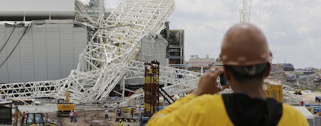 A metal structure atop of the Itaquerao Stadium is seen after a collapse in Sao Paulo, Brazil, Wednesday, Nov. 27, 2013. Part of the Itaquerao stadium that will host the 2014 World Cup opener in Brazil collapsed on Wednesday, causing significant damage and killing three people, authorities said. (AP Photo/Nelson Antoine)