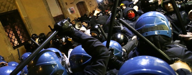 Protesters clash with police during a protest against the Turin-Lyon high speed train line, in Rome Wednesday, Nov. 20, 2013. The construction of the fast train line, linking Turin to Lyon in France, has raised environmentalists' protests as well as that of the residents of the Susa valley contending that the new line is not an economic priority and that it will spoil the area. The protest took place as Italian Premier Enrico Letta was meeting with French President Francois Hollande. (AP Photo/Gregorio Borgia)