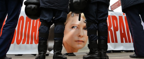Ukrainian riot policemen stand in front of activists holding a banner bearing the picture of Yulia Tymoshenko and reading &#8220;Free Yulia, free Ukraine&#8221; during a demonstration by opposition activists held in front of the parliament in Kiev on November 13, 2013. Ukraine&#8217;s prospects of signing a potentially historic deal with the European Union were dealt a possibly fatal blow Wednesday after parliament failed to agree a bill that would allow the release of jailed ex-premier Yulia Tymoshenko. AFP PHOTO/ SERGEI SUPINSKY (Photo credit should read SERGEI SUPINSKY/AFP/Getty Images)
