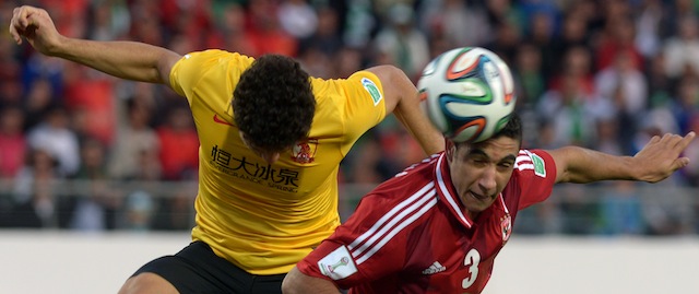 Guangzhou's Brazilian mildfielder Elkeson (L) is defended by Al Ahly's Egyptian defender Rami Rabia (R) during their FIFA Club World Cup quarter final football match in the coastal Moroccan city of Agadir on December 14, 2013. This year's competition is being staged in Morocco from December 11-21, with games being played in Agadir and Marrakesh. AFP PHOTO / FADEL SENNA (Photo credit should read FADEL SENNA/AFP/Getty Images)