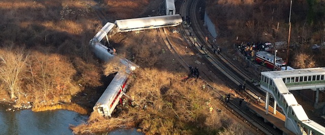 Cars from a Metro-North passenger train are scattered after the train derailed in the Bronx neighborhood of New York, Sunday, Dec. 1, 2013. The Fire Department of New York says there are "multiple injuries" in the train derailment, and 130 firefighters are on the scene. Metropolitan Transportation Authority police say the train derailed near the Spuyten Duyvil station. (AP Photo/Edwin Valero)