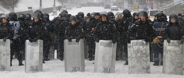 Ukrainian riot police block Pro-European Union activists gathered on the Independence Square in Kiev, Ukraine, Monday, Dec. 9, 2013. The policemen, wearing helmets and holding shields, formed a chain across Kiev’s main street outside the city building. Organizers called on protesters to vacate the city hall and the other building which the opposition had used as its headquarters. (AP Photo/Sergei Grits)