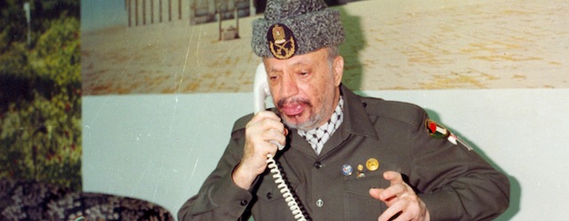 ** FOR EDITORIAL USE ONLY ** This is an undated file photograph of Palestinian leader Yasser Arafat speaking on the phone, made available by the Palestinian Authority in Gaza City of the Gaza Strip. (AP Photo/Palestinian Authority)