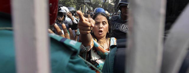 A supporter of the ruling Bangladesh Awami League shouts slogans during a clash with the supporters of the Bangladesh's main opposition Bangladesh Nationalist Party in Dhaka, Bangladesh, Monday, Dec. 30, 2013. Ruling party supporters and their opponents threw stones at each other Monday on the second day of sporadic violence in the Bangladeshi capital, after heavy police presence foiled an opposition plan for a rally to pressure the government to scrap next month's election.(AP Photo/A.M. Ahad)