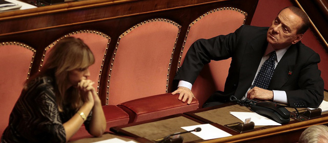 Italian center-right leader Silvio Berlusconi (R) looks on at the Senate in Rome, October 2, 2013. Italian Prime Minister Enrico Letta said on Wednesday his government could achieve reforms even with a smaller majority, as he wound up a debate on a confidence vote in which he has been boosted by dissidents from Berlusconi's centre-right party. REUTERS/Tony Gentile (ITALY - Tags: POLITICS)