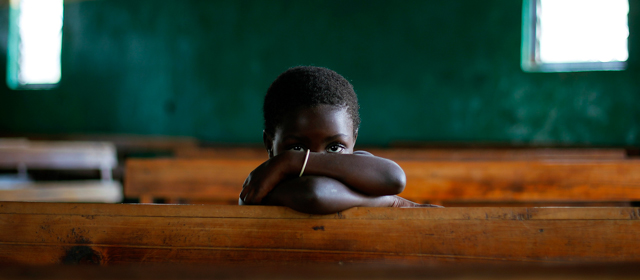 A Congolese child sits in the Kiwanja catholic church, North of Rutshuru, 75 km (48 miles) North of Goma, Congo, Sunday Aug. 5, 2012. 2012. Congo's army now controls only the city of Goma and the village of Kibumba, 10 kilometers (six miles) outside Goma. Now the rebels hold all towns going north as far as Rutshuru and are threatening to besiege Goma. The U.N. Security Council on Thursday demanded that the M23 rebel group halt any advances toward Goma. (AP Photo/Jerome Delay)