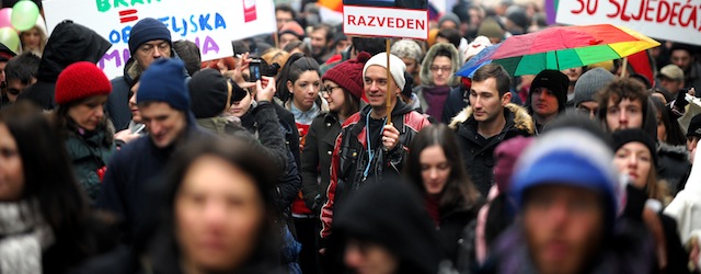 Croatian gay rights supporters hold a picture of Tomislav Karamarko, leader of the conservative opposition Croatian Democratic Union party, reading "Divorced" as they gather for a protest in Zagreb on November 30, 2013 on the eve of a constitutional referendum that could outlaw same-sex marriage in the EU's newest member state. More than 1,000 people braved the cold and rainy weather to gather in a square in conservative and mainly Catholic Croatia for a protest march against the vote, which they see as discriminatory. AFP PHOTO/STR (Photo credit should read STR/AFP/Getty Images)