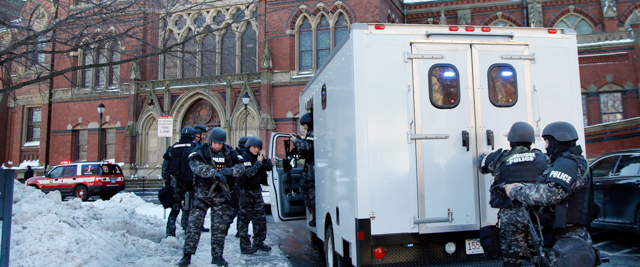 SWAT team officers arrive at a building at Harvard University in Cambridge, Mass., Monday, Dec. 16, 2013. Four buildings on campus were evacuated Monday after campus police received an unconfirmed report that explosives may have been placed inside, interrupting final exams. (AP Photo/Elise Amendola)