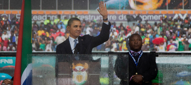 President Barack Obama waves as he arrives to speak to crowds attending the memorial service for former South African president Nelson Mandela at the FNB Stadium in Soweto near Johannesburg, Tuesday, Dec. 10, 2013. World leaders, celebrities, and citizens from all walks of life gathered on Tuesday to pay respects during a memorial service for the former South African president and anti-apartheid icon. (AP Photo/Evan Vucci)