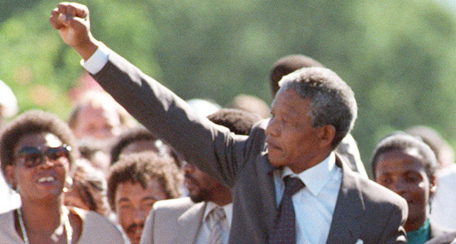 PAARL, SOUTH AFRICA - FEBRUARY 11: ANC leader Nelson Mandela and wife Winnie raise fists upon his release from Victor Verster prison, 11 February 1990 in Paarl. (Photo credit should read ALEXANDER JOE/AFP/Getty Images)