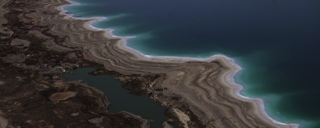 An aerial view photo shows sinkholes created by the drying of the Dead Sea, near Kibbutz Ein Gedi, on November 10, 2011. The Dead Sea is one of the sites candidate of other 28 sits in a international online campaign votes to select the new Seven Wonders of World Heritage Sites. AFP PHOTO / MENAHEM KAHANA (Photo credit should read MENAHEM KAHANA/AFP/Getty Images)