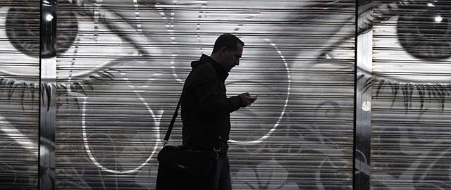 A man looks at his cell phone as he walks on the street in downtown Madrid, Thursday, Oct. 31, 2013. On Wednesday Spain's Prime Minister Mariano Rajoy said that the head of Spain's intelligence services will address Parliament over allegations that Spain was a target for surveillance by the U.S. National Security Agency. He reiterated that if confirmed, such activity is “inappropriate and unacceptable between partners and friends.” (AP Photo/Francisco Seco)