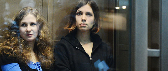 A file picture taken on October 10, 2012, shows two jailed members of the all-girl punk band "Pussy Riot," (L-R) Maria Alyokhina and Nadezhda Tolokonnikova, sitting in a glass-walled cage in a court in Moscow. Alyokhina and Tolokonnikova have fired their legal team and hired the lawyer who helped free their band mate, the husband of one of the women told AFP. AFP PHOTO / NATALIA KOLESNIKOVA (Photo credit should read NATALIA KOLESNIKOVA/AFP/Getty Images)