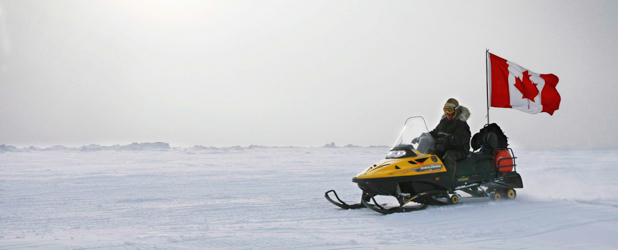 In this March 31, 2007 photo, Ranger Joe Amarualik, from Iqaluit, Nunavut, drives his snowmobile on the ice during a Canadian Ranger sovereignty patrol near Eureka, on Ellesmere Island, Nunavut. Canada plans to make a claim to the North Pole in an effort to assert its sovereignty in the resource-rich Arctic, the country's foreign affairs minister said Monday, Dec. 9, 2013. (AP Photo/The Canadian Press, Jeff McIntosh)