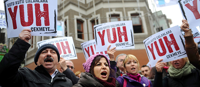 People hold placards reading "Shame to thieves with Boxes" during a demostration on December 29, 2013 in Istanbul against corruption and the Government. Turkish Prime Minister Recep Tayyip Erdogan lashed out at the judiciary as he tried to tamp down a corruption probe that has shaken his government and sparked a new wave of anti-government protests. The conservative prime minister, who has dug in his heels over the crisis that has led to the resignation of three ministers, went again on the attack during a speech in the southern city of Manisa. AFP PHOTO / OZAN KOSE (Photo credit should read OZAN KOSE/AFP/Getty Images)