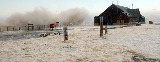 The tide turns to froth by the Lifeboat Station on the promenade as waves batter the sea wall in Blackpool, north west England, on December 5, 2013 as high winds hit the north of England and Scotland. A storm lashed Scotland and other parts of Britain with gusts of up to 142 mph (228 kmh), killing one person. AFP PHOTO / PAUL ELLIS (Photo credit should read PAUL ELLIS/AFP/Getty Images)