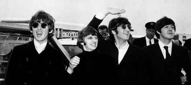 Pop group The Beatles, waving to screaming fans en route to Boston airport, America, from left to right, George Harrison, Ringo Starr, John Lennon and Paul McCartney, on August 12, 1966. (Photo by Daily Express/Archive Photos/Getty Images)