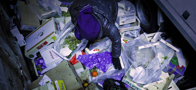 A woman collects food waste at the main food market on December 28, 2011 in Madrid. The poor scavenge for discarded fruit and food, hunting Among the delivery trucks at the Mercamadrid. Their plight is bleak evidence of Spain's stalled economy, and a queue of five million jobless people. AFP PHOTO/Pedro ARMESTRE (Photo credit should read PEDRO ARMESTRE/AFP/Getty Images)