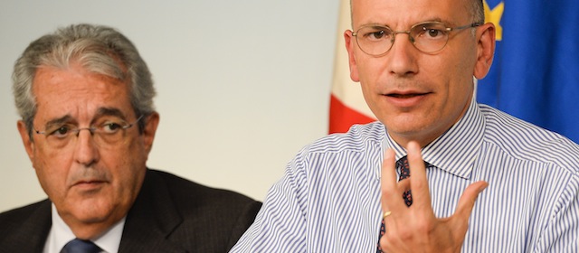 Italian Prime Minister Enrico Letta (R) gives a press conference with Italian Finance Minister Fabrizio Saccomanni on August 28, 2013 following a cabinet meeting at the Palazzo Chigi in Rome. Italy's bickering coalition clinched a deal on on August 28 to scrap an unpopular property tax, staving off the prospect of a government collapse under pressure from Silvio Berlusconi. AFP PHOTO / ANDREAS SOLARO (Photo credit should read ANDREAS SOLARO/AFP/Getty Images)