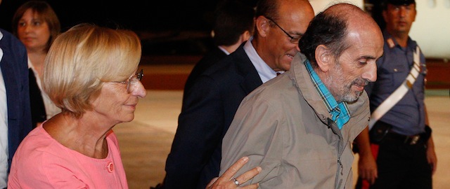 Italian Foreign Minister Emma Bonino (L) greets Italian journalist Domenico Quirico who was kidnapped in Syria in early April, after his disembark from the airplane on September 9, 2013 at Ciampino military airport in Rome. AFP PHOTO / ANDREAS SOLARO (Photo credit should read ANDREAS SOLARO/AFP/Getty Images)