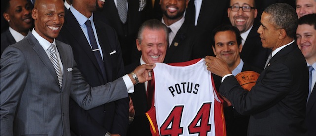 US President Barack Obama receive a jersey from Ray Allen of the Miami Heat during an event honoring the 2013 NBA Champions, the Miami Heat, in the East Room of the White House in Washington, DC on january 14, 2014. AFP PHOTO/Mandel NGAN (Photo credit should read MANDEL NGAN/AFP/Getty Images)