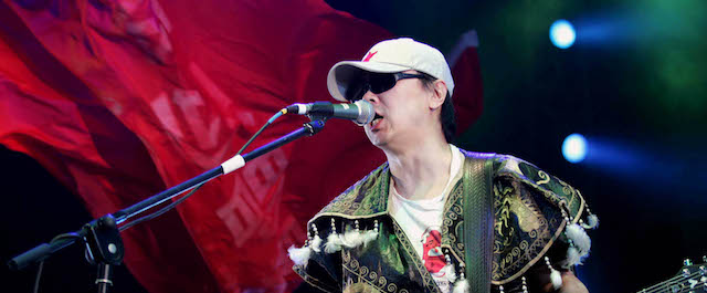 Cui Jian, known as the "Father of China's Rock-and-Roll", performs during his solo concert at Hongshan Stadium in Wuhan, capital city of central China's Hubei Province, Friday, June 3, 2005. (AP PhotoXinhua, Zhou Guoqiang)