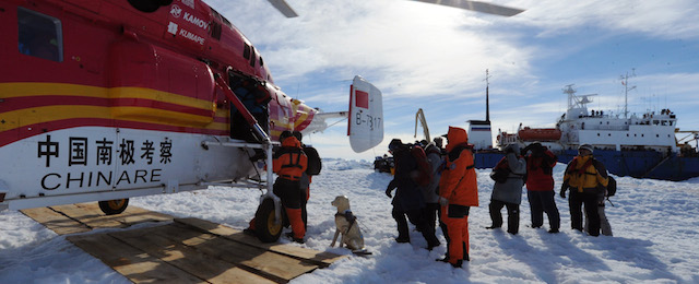 In this photo provided China's official Xinhnua News Agency, passengers from the trapped Russian vessel MV Akademik Shokalski, seen at right, prepare to board the Chinese helicopter Xueying 12 in the Antarctic Thursday, Jan. 2, 2014. A helicopter rescued all 52 passengers from the research ship that has been trapped in Antarctic ice, 1,500 nautical miles south of Hobart, Australia, since Christmas Eve after weather conditions finally cleared enough for the operation Thursday. (AP Photo/Xinhua, Zhang Jiansong) NO SALES