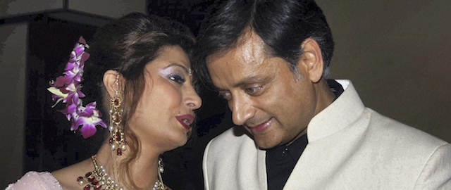 FILE – In this Sept. 4, 2010 file photo, former Indian Junior Foreign Minister Shashi Tharoor listens to his wife Sunanda Pushkar at their wedding reception in New Delhi, India. Police say on Friday, Jan. 17, 2014, they have found the body of the wife of an Indian federal minister in a New Delhi hotel room after a controversy over her husband's alleged affair with a Pakistani journalist. Officer Rakesh Kumar says police are investigating the cause of Sunanda Pushkar's death. (AP Photo/File)