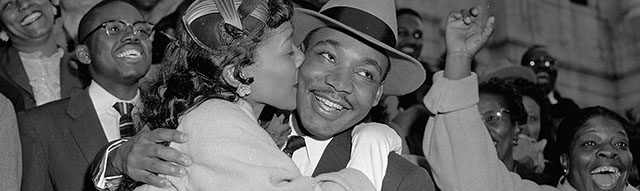 The Rev. Martin Luther King Jr. is welcomed with a kiss by his wife Coretta after leaving court in Montgomery, Ala., March 22, 1956. King was found guilty of conspiracy to boycott city buses in a campaign to desegregate the bus system, but a judge suspended his $500 fine pending appeal. (AP Photo/Gene Herrick)