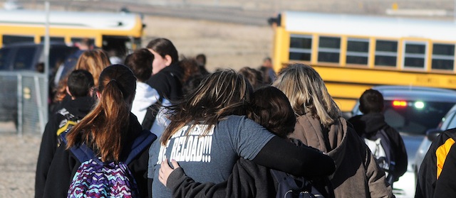 Mark Wilson Photo
Students are escorted from Berrendo Middle School in Roswell, New Mexico following an early morning shooting, Tuesday, January 14, 2014. (AP Mark Wilson/Roswell Daily Record)