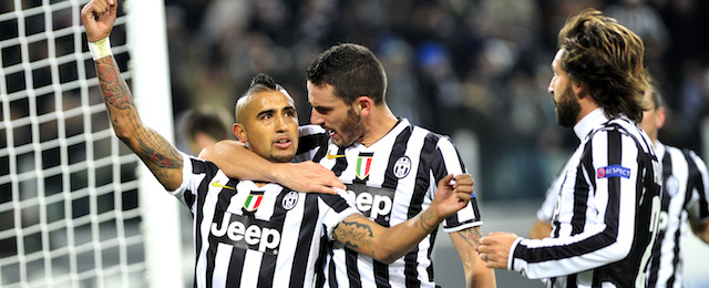 Juventus midfielder Arturo Vidal, left, celebrates with teammates Leonardo Bonucci and Andrea Pirlo, right, after scoring during the Champions League, Group B, soccer match between Juventus and Copenaghen at the Juventus stadium, in Turin, Italy, Wednesday, Nov. 27, 2013. (AP Photo/Massimo Pinca)