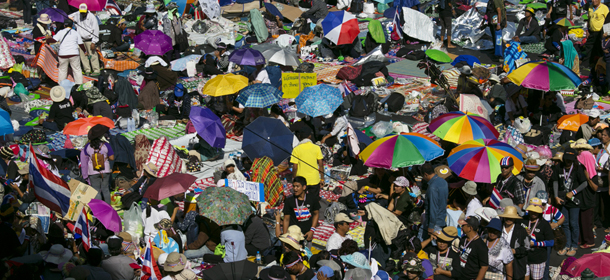 BANGKOK, THAILAND - JANUARY 13: Anti-government protesters sit at Asok intersection in downtown Bangkok on the first day of the " Bangkok Shutdown ", Thailand on January 13, 2014. Anti-government protesters launch "Bangkok Shutdown", blocking major intersections in the heart of the capital, as part of their bid to oust the government of Prime Minister Yingluck Shinawatra ahead of elections scheduled to take place on February 2. (Photo by Paula Bronstein/Getty Images)