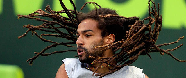 Dustin Brown of Germany returns the ball to Peter Gojowczyk during the Qatar ATP Open Tennis tournament in Doha, Qatar,Thursday, Jan. 2, 2014. (AP Photo/Osama Faisal)