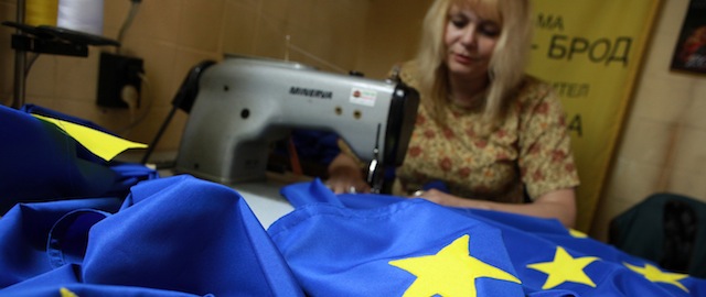 A woman embroiders a European Union flag at a small flag producing factory in the Bulgarian capital Sofia, Saturday, May, 8, 2010. Bulgaria, which joined the European Union in January 2007, is preparing to mark Europe Day on May 9. (AP Photo/Petar Petrov)