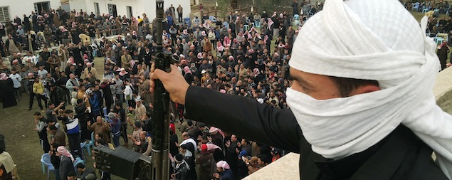 An armed Iraqi man stands guard as people gather to protest near the home of arrest Sunni Muslim MP Ahmed al-Alwani in Ramadi, west of Baghdad, on December 29, 2013. Iraqi security forces raided the home of a Sunni MP who backs anti-government protesters, arresting him on December 28, and sparking clashes that killed his brother and five guards, police said. AFP PHOTO/AZHAR SHALLAL (Photo credit should read AZHAR SHALLAL/AFP/Getty Images)