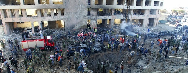 A general view shows the site of an explosion in Beirut 14 February 2005. Lebanon's former prime minister Rafiq Hariri was killed in the huge explosion in central Beirut, hospital sources said. The blast set ablaze cars and devastated buildings in a seafront area of the Lebanese capital on Monday, leaving smouldering bodies in the streets. AFP PHOTO/ANWAR AMRO (Photo credit should read ANWAR AMRO/AFP/Getty Images)