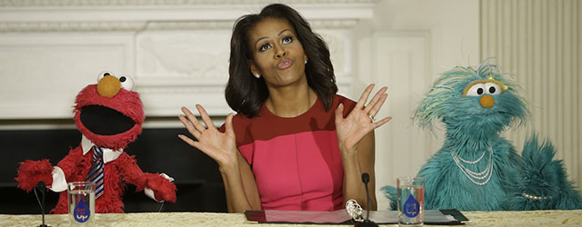 First lady Michelle Obama, center, with PBS Sesame Street's characters Elmo, left, and Rosita, right, to help promote fresh fruit and vegetable consumption to kids in an event in the State Dining Room of the White House in Washington, Wednesday, Oct. 30, 2013. Sesame Workshop and the Produce Marketing Association (PMA) joined in Partnership for a Healthier America (PHA) in announcing a 2-year agreement to making healthy choices by using the Sesame Street characters to help deliver the messages about fresh fruits and vegetables. (AP Photo/Pablo Martinez Monsivais)