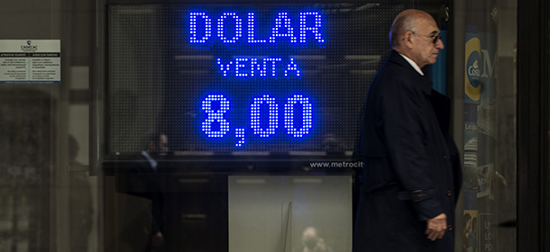 The board of an exchange house in downtown Buenos Aires reads the rate of 8.00 argentine pesos to one dollar on January 24, 2014. Argentina on Friday lifted restrictions in place since 2011 that limited the purchase of foreign currency, a day after the peso suffered its worst single-day dive since the 2002 financial crisis. The government has decided "to authorize the purchase of dollars for holding or savings," said Jorge Capitanich, President Cristina Kirchner's cabinet chief. The restrictions had always been temporary and had served their purpose. AFP PHOTO / LEO LA VALLE (Photo credit should read LEO LA VALLE/AFP/Getty Images)