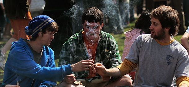 BOULDER, CO - APRIL 20: Young men smoke a marijuana cigarette during a "smoke out" with thousands of others April 20, 2010 at the University of Colorado in Boulder, Colorado. April 20th has become a de facto holiday for marijuana advocates, with large gatherings and "smoke outs" in many parts of the United States. Colorado, one of 14 states to allow use of medical marijuana, has experienced an explosion in marijuana dispensaries, trade shows and related businesses in the last year as marijuana use becomes more mainstream here. (Photo by Chris Hondros/Getty Images)