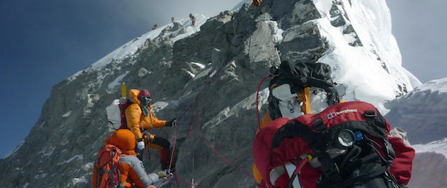 Unidentified mountaineers walk past the Hillary Step while pushing for the summit of Everest on May 19, 2009, as they climb the south face from Nepal. Bad weather conditions forced three Nepalese Sherpa brothers to give up their plans to set a new world record by spending 24 hours in the "death zone" on top of Mount Everest. Pemba Dorje Sherpa, 30, and his two younger brothers reached the summit on May 19, but were forced down after only two hours, Pemba told AFP after returning to Kathmandu. AFP PHOTO/COURTESY OF PEMBA DORJE SHERPA (Photo credit should read STR/AFP/Getty Images)