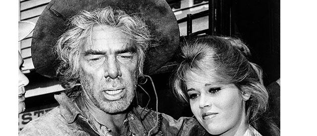 Actress Jane Fonda gets some tips on how to handle a six shooter from actor Lee Marvin during a break in filming of the Western movie "Cat Ballou" in Hollywood, Ca., 1964. (AP Photo)