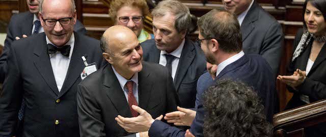 Democrats Party lawmaker Pierluigi Bersani is greeted by his colleagues as he arrives prior to a confidence vote in the Chamber of Deputies, in Rome, Tuesday, Feb. 25, 2014. The Senate voted 169-139 to confirm Renzi's broad coalition, which ranges from his center-left Democrats to center-right forces formerly loyal to ex-premier Silvio Berlusconi. Renzi needed at least 155 votes to clinch the victory, one of two mandatory confidence votes. The second vote, in the Chamber of Deputies, is expected later Tuesday. Renzi's coalition has a comfortable majority in the lower chamber. (AP Photo/Andrew Medichini)