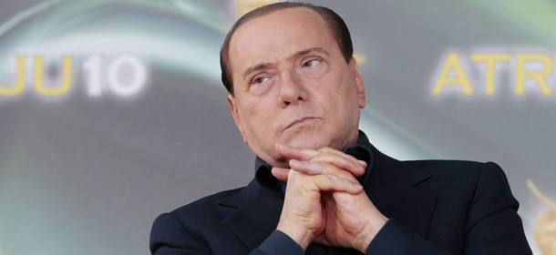 Italian Premier Silvio Berlusconi reacts at the end of his address at the People of Freedom party meeting in Rome, Sunday, Sept. 12, 2010. Berlusconi will speak to parliament at the end of the month in a highly anticipated address that could determine the fate of his government. The speech will be Berlusconi's first major parliament appearance since he split with longtime ally Gianfranco Fini. The split potentially deprived Berlusconi of his once-solid parliamentary majority, leaving the fate of his government uncertain. (AP Photo/Gregorio Borgia)