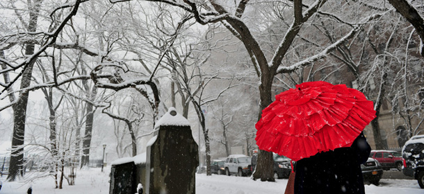 A woman stands on Fifth Avenue at an entrance to Central Park February 3, 2014 on the east side of Manhattan as a snowstorm hits New York. AFP PHOTO/Stan HONDA (Photo credit should read STAN HONDA/AFP/Getty Images)