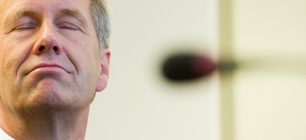 German ex-President Christian Wulff grimaces as he arrives for his trial at a court in Hannover, northern Germany, Thursday, Nov. 14, 2013. Wulff has gone on trial on corruption charges in an attempt to clear his name of allegations that helped lead to his resignation. He is charged with accepting favors while in office. In April he rejected settling his case with a fine, insisting he was innocent. (AP Photo/Julian Stratenschulte, Pool)