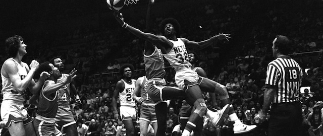The New York Nets' Julius Erving, known as Doctor J., hooks in his 9,994th basket as a professional against the St. Louis Spirits, December 27, 1975. Erving scored 27 points in the game. He is in his fifth season as a professional. (AP Photo/Harry Harris)