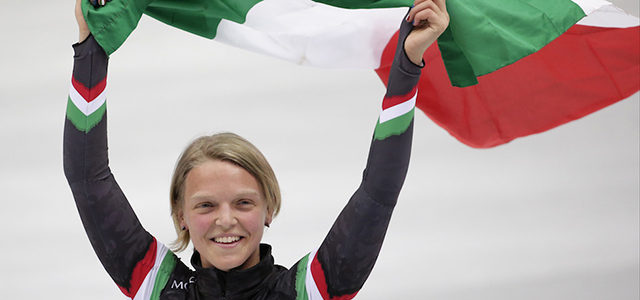 Arianna Fontana of Italy celebrates with the national flag after placing second in the women's 500m short track speedskating final at the Iceberg Skating Palace during the 2014 Winter Olympics, Thursday, Feb. 13, 2014, in Sochi, Russia. (AP Photo/Bernat Armangue)