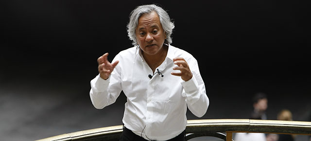 Indian born British artist Anish Kapoor answers reporters in front of his artwork entitled Leviathan, on the eve of the opening of an exhibition of his work at the Grand Palais in Paris, Tuesday May 10, 2011. The 35-meter high air inflated monochrome Leviathan enables people to circumnavigate, and walk inside, the work which fills the cavernous Grand Palais, and is presented here until June 23. (AP Photo/Remy de la Mauviniere)